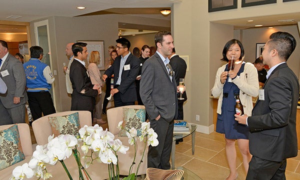 Students networking event talking at a lobby